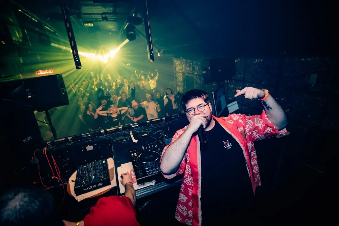 Callum on stage at Anime Disco with the crowd behind him