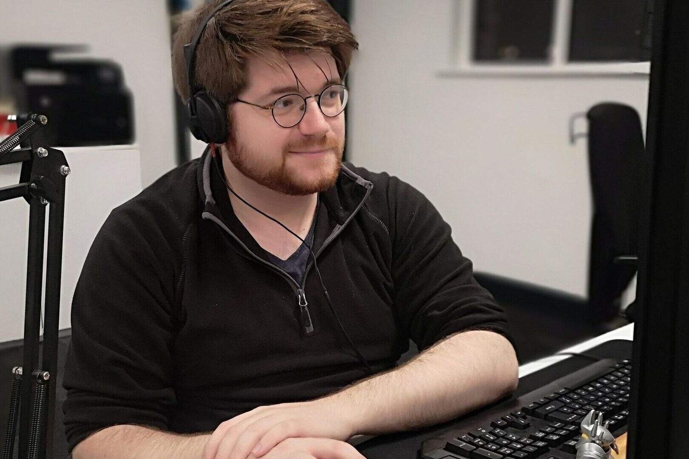 Callum Janes working at a desk at Farset Labs