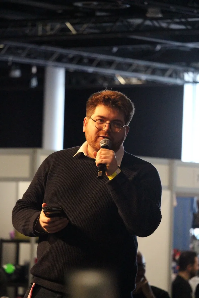 Callum Janes on stage with a microphone