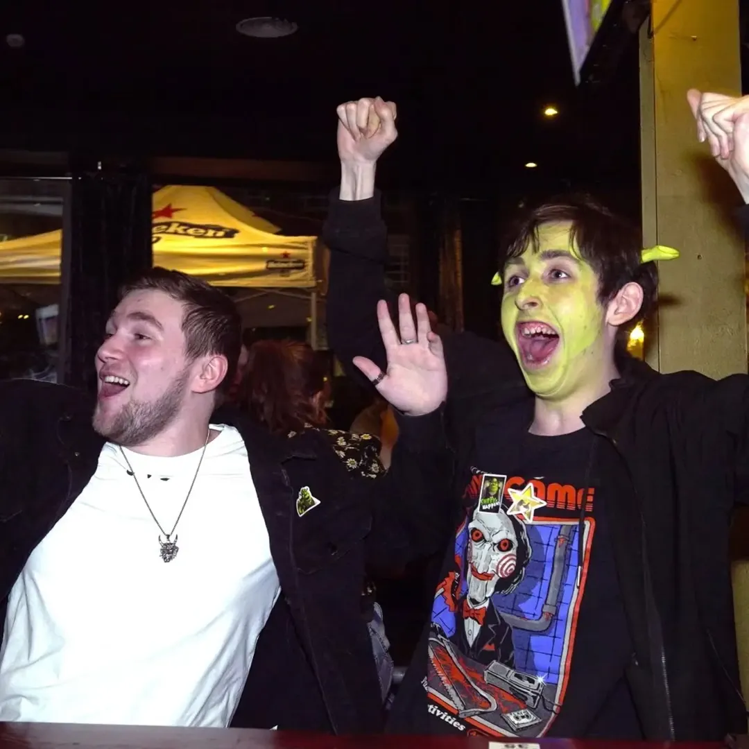 Attendees in Shrek facepaint cheering